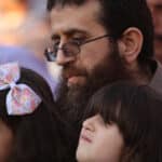 Khader Adnan with his children during a rally in the Jenin town of Arrabeh honoring him following his release from Israeli prisons, July 12, 2015. Adnan would later die in Israeli custody on May 2, 2023, while nearing his 90th day on hunger strike protesting his imprisonment. Photo: Ahmad Talat/APA Images.