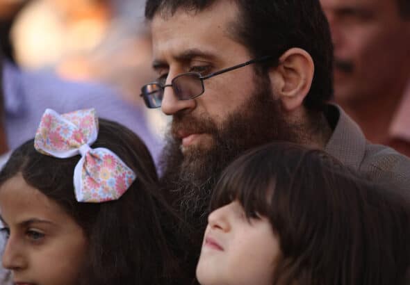Khader Adnan with his children during a rally in the Jenin town of Arrabeh honoring him following his release from Israeli prisons, July 12, 2015. Adnan would later die in Israeli custody on May 2, 2023, while nearing his 90th day on hunger strike protesting his imprisonment. Photo: Ahmad Talat/APA Images.