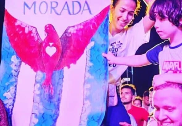 Fans raise a banner wtih the cover picture of the Cuban music duo Buena Fe's latest album Morada. Photo: Prensa Latina.