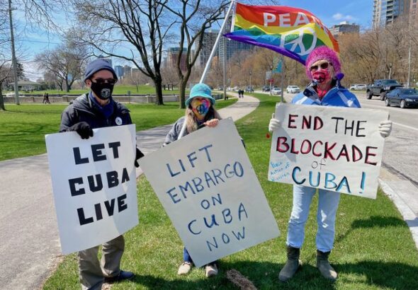 US activists holding banners showing their solidarity with Cuba. Photo: Susan Ruggles.