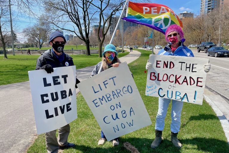 US activists holding banners showing their solidarity with Cuba. Photo: Susan Ruggles.