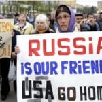 A woman holds a poster which reads \"Russia is our friends, USA do home\" during a pro-Russian rally in Kharkiv on April 21. Photo: Anastasia Vlasova.