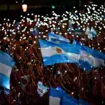 A crowd waves several Argentinian flags. Photo: Al Jazeera.