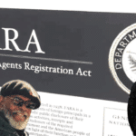 Photo composition showing African People Socialist Party Chairman Omali Yeshitela with his fist in the air (left) and an FBI agent (right) on a screen of the FARA website in the background. Photo: Orinoco Tribune.