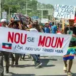 Bwa kale protesters carrying a banner that reads 'Nou se moun fòk nou viv tankou moun,' which translates to 'We are people we have to live like people' during a demonstration on Oct. 17, 2022 in Port-au-Prince. Photo: Marvens Compere/The Haitian Times.