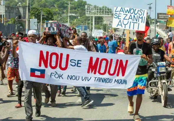 Bwa kale protesters carrying a banner that reads 'Nou se moun fòk nou viv tankou moun,' which translates to 'We are people we have to live like people' during a demonstration on Oct. 17, 2022 in Port-au-Prince. Photo: Marvens Compere/The Haitian Times.