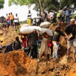 Local residents make their way through a seriously damaged road following heavy rains that caused floods and landslides, on the outskirts of Kinshasa, Democratic Republic of Congo, Dec 14 2022. Photo: Reuters/Justin Makangara/Referential photo.