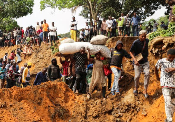 Local residents make their way through a seriously damaged road following heavy rains that caused floods and landslides, on the outskirts of Kinshasa, Democratic Republic of Congo, Dec 14 2022. Photo: Reuters/Justin Makangara/Referential photo.