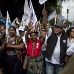 Thelma Cabrera, Guatemalan indigenous activist and presidential aspirant from the MLP party; Neftalí Matías López Miranda, indigenous scholar and political consultant; and their supporters arriving at the Plaza de la Constitución during the closing of the MLP's campaign. Photo: Simone Dalmasso.