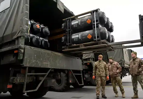 A group of Ukrainian soldiers receive a shipment of US-made missiles in early February, 2022. Photo: AFP/Sergey Supinsky.
