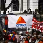Venezuelan people in a street protest with banners of CITGO and PDVSA. Photo: Bloomberg.
