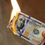 One hundred dollar note on fire. Photo: chinausfocus.com.