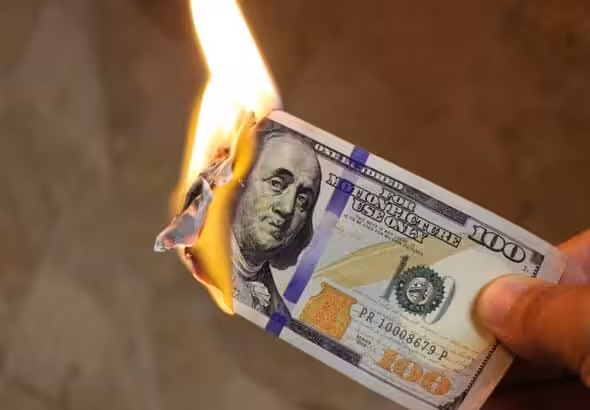 One hundred dollar note on fire. Photo: chinausfocus.com.