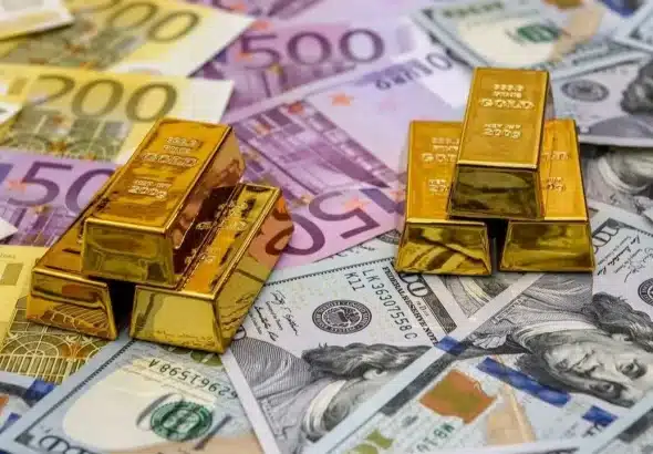 Gold bullions on dollar and euro notes. File photo.