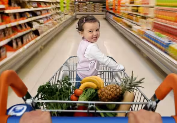 A baby on a shopping cart. Photo: Getty Images/Caroline Purser.