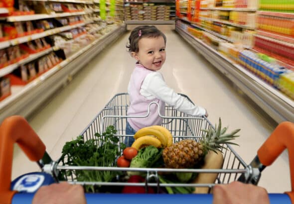A baby on a shopping cart. Photo: Getty Images/Caroline Purser.