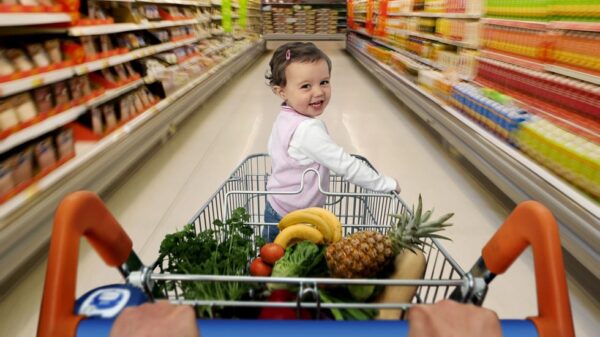 A baby on a shopping cart. Photo: Getty Images/Caroline Purser.