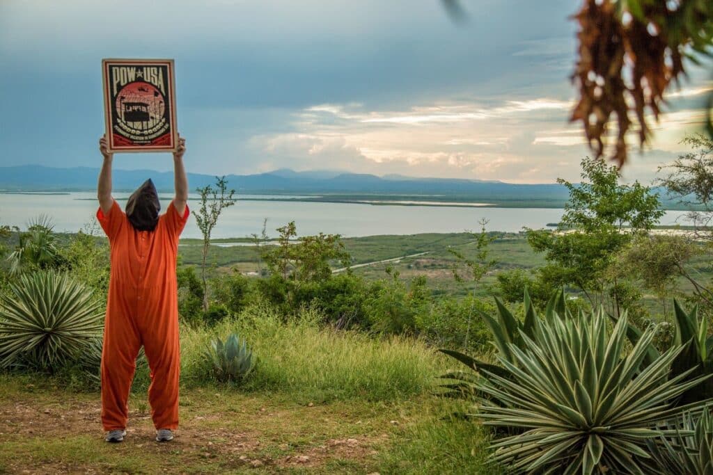 Featured image: Shepard Fairey Sign at Guantánamo Bay. Photo: Justin Norman is licensed under CC BY-SA 2.0/Flickr.