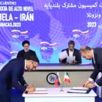 Venezuelan and Iranian minister for communication and information signing a bilateral agreement at Miraflores Palace in Caracas, with President Raisi and President Maduro in the background chairing the ceremony on Monday, June 12, 2023. Photo: Venezuela's Presidential Press.