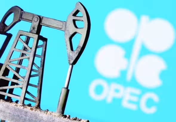 Miniature oil well with the OPEC logo in the background. File photo.