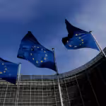 Three EU flags fly outside the EU Commission headquarters in Brussels, Belgium. Photo: Yves Herman/Reuters.