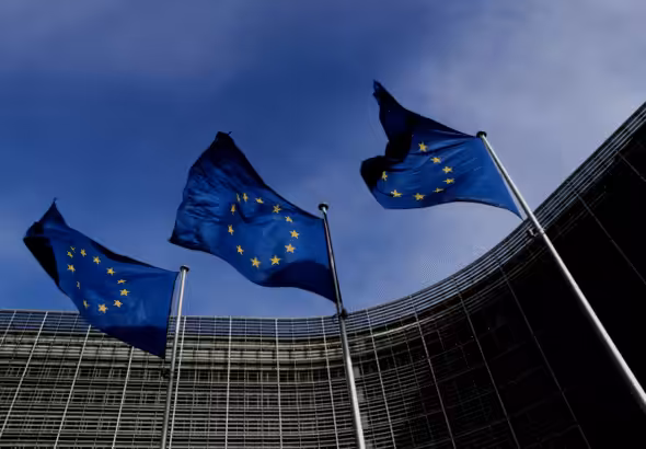 Three EU flags fly outside the EU Commission headquarters in Brussels, Belgium. Photo: Yves Herman/Reuters.