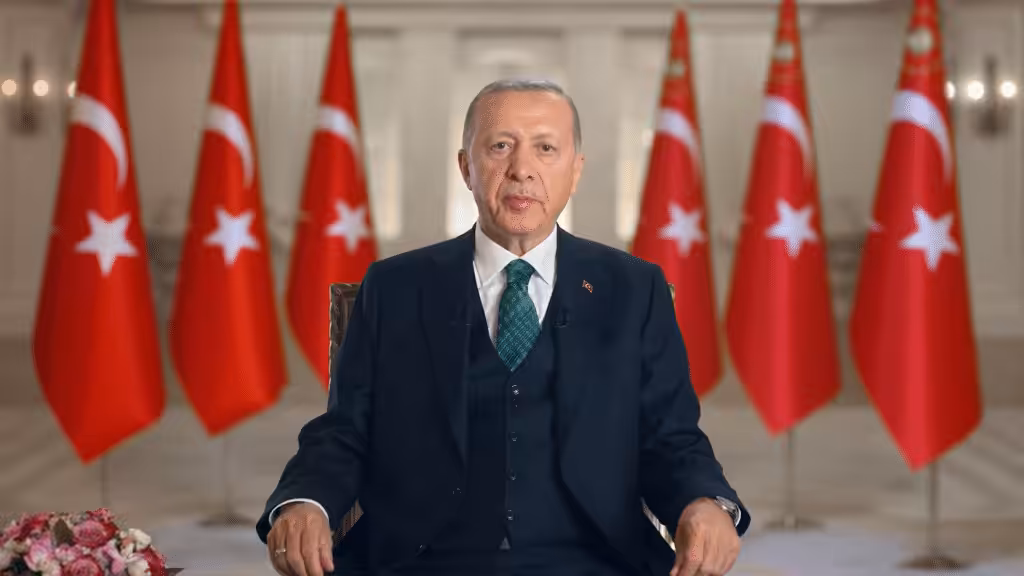 Turkish President Recep Tayyip Erdoğan with flags of Turkey in the background. File photo.