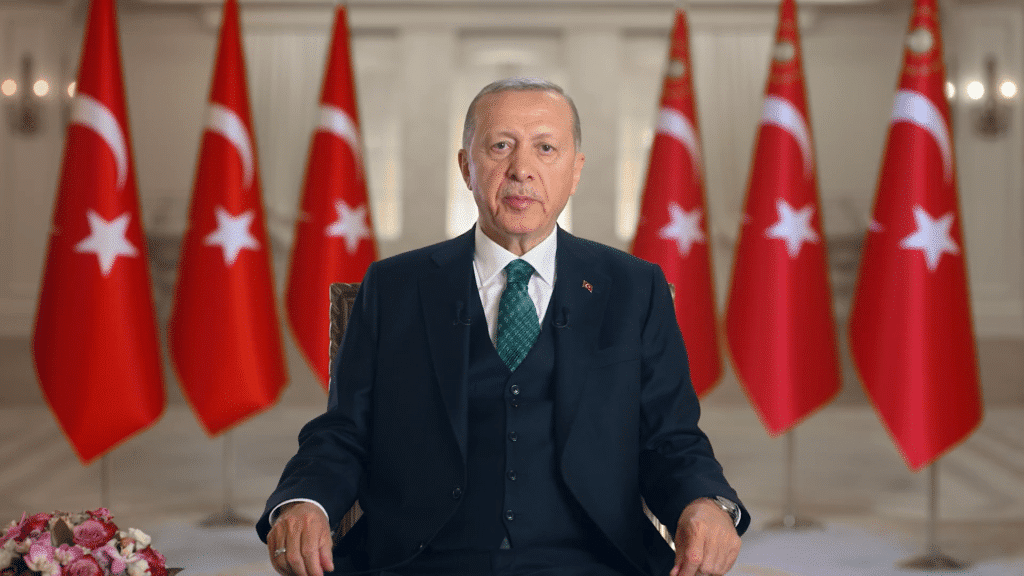 Turkish President Recep Tayyip Erdoğan with flags of Turkey in the background. File photo.