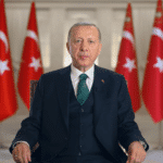 Turkish President Recep Tayyip Erdoğan with flags of Turkey in the background. File photo.