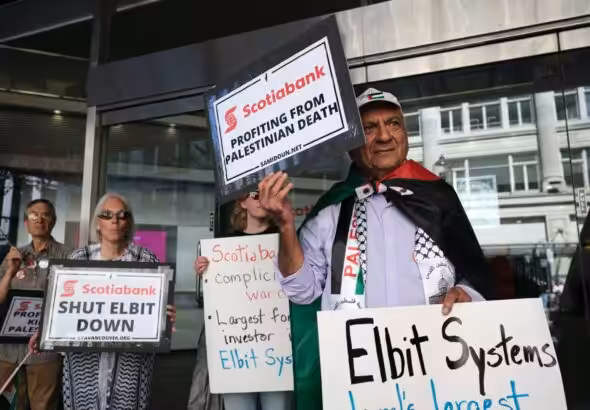 Palestine solidarity activists in Vancouver Canada hold a rally outside the Scotiabank Towers to protest the bank’s investment in elbit systems, June 3, 2023. Photo: Michael Yc Tseng.