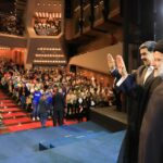 Iranian President Ebrahim Raisi (right) next to Venezuelan President Nicolas Maduro (left) greeting attendees at a youth forum held at the Teresa Carreno Theater in Caracas on Tuesday, June 13, 2023. Photo: Twitter/@NicolasMaduro.