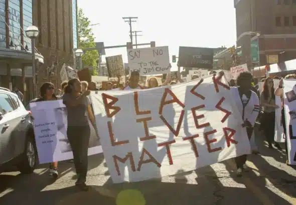 Protesters holding a banner that reads 'Black Lives Matter.’ Photo: AFGJ/File photo.