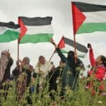 Palestinian women raising the Palestinian flag. File photo.