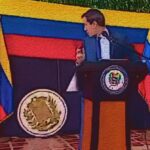 Stylized screenshot of an awkward moment during Juan Guaidó's so-called "interim presidency," when an improvised Venezuelan coat of arms fell while in the middle of one of his unintelligible speeches. Photo: Venezuelanalysis.com/File photo.