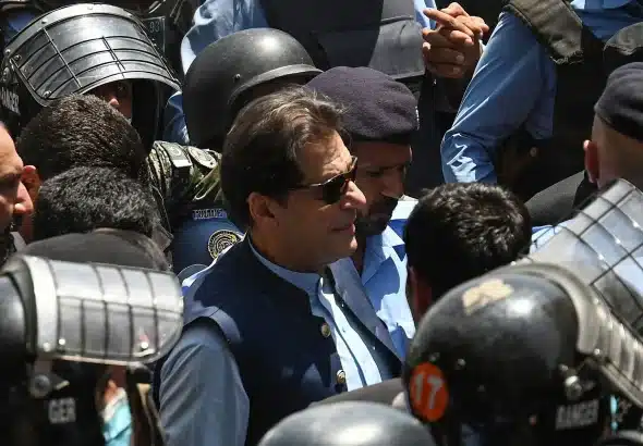 Police commandos escort former Pakistan Prime Minister Imran Khan as he arrives at the high court in Islamabad on May 12, 2023.
