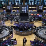 Aerial view of a trader walking through the trading floor at the New York Stock Exchange (NYSE). Photo: Andrew Kelly/Reuters.