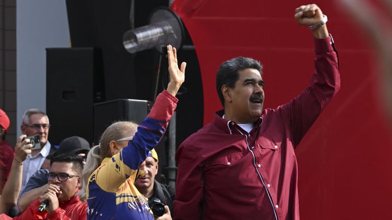 Venezuela's President Nicolas Maduro (Right) and his wife Cilia Flores (Left) at a rally in Caracas, April 13, 2023. Photo: Yuri Cortez/AFP.