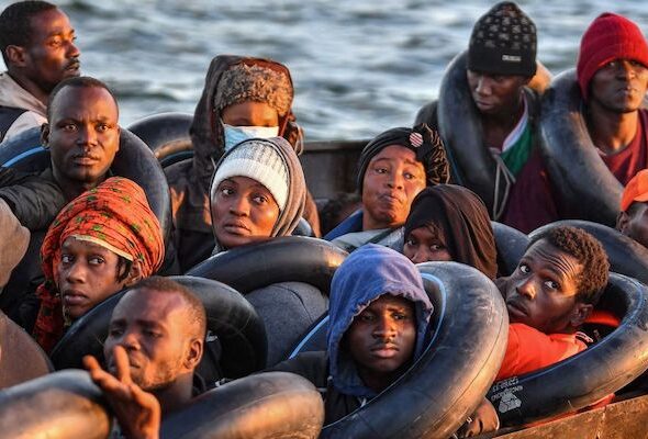 Migrants from sub-Saharan Africa, pictured on October 4, 2022, sit in a makeshift boat as they travel towards the Italian coast. Photo: Black Agenda Report/File photo.