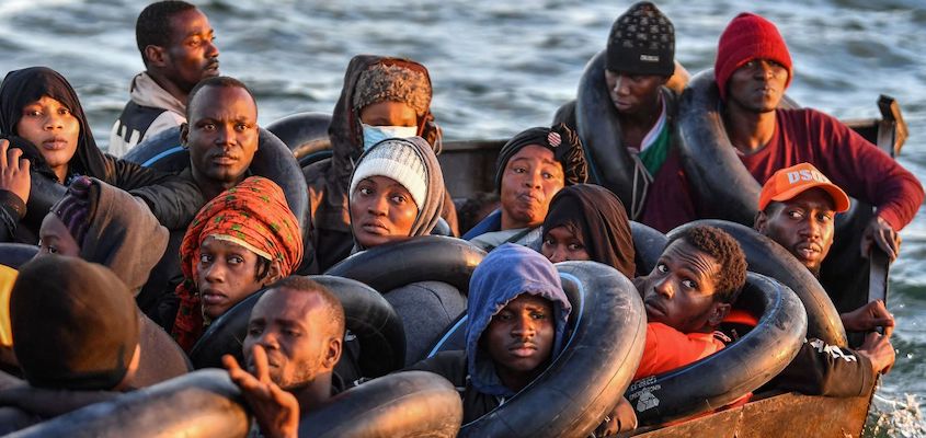 Migrants from sub-Saharan Africa, pictured on October 4, 2022, sit in a makeshift boat as they travel towards the Italian coast. Photo: Black Agenda Report/File photo.