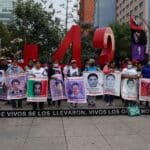 Family members and friends of the 43 disappeared students of Ayotzinapa marching to demand justice with their photos at the Angel of Independence monument in Mexico City, May 26, 2023. Photo: Galo Cañas/Cuartoscuro.