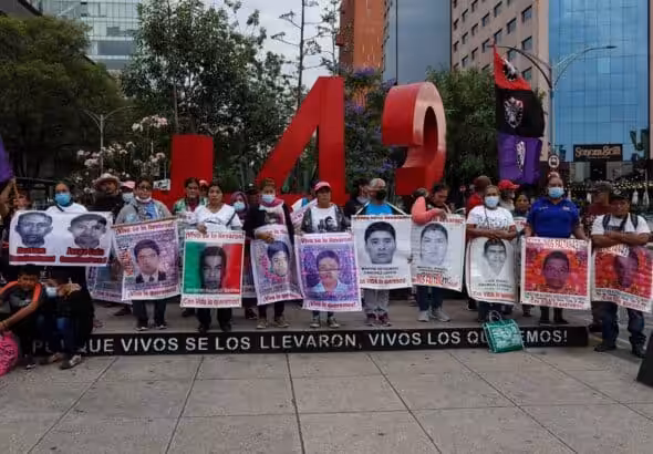 Family members and friends of the 43 disappeared students of Ayotzinapa marching to demand justice with their photos at the Angel of Independence monument in Mexico City, May 26, 2023. Photo: Galo Cañas/Cuartoscuro.