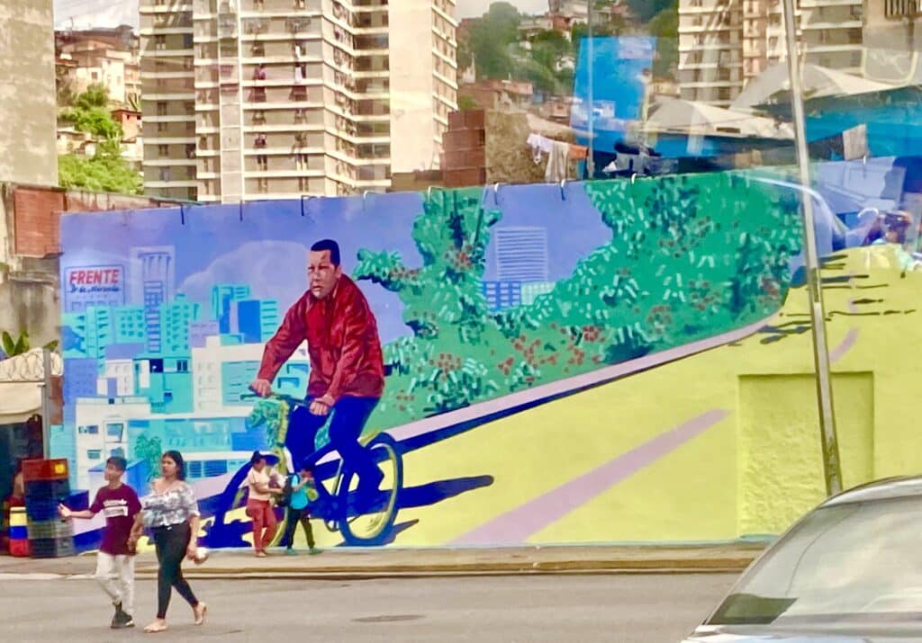 Mural in Caracas showing President Hugo Chávez riding a bike. Photo: Twitter/@adriennepine.