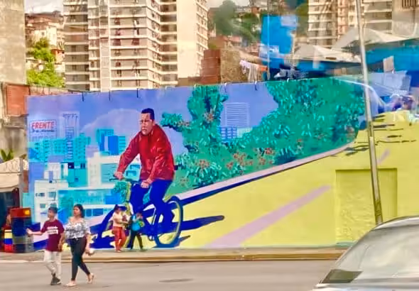 Mural in Caracas showing President Hugo Chávez riding a bike. Photo: Twitter/@adriennepine.