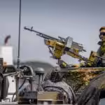 A Swedish soldier on top on an armored military vehicle in what seems to be a military drill. Photo: Getty Images