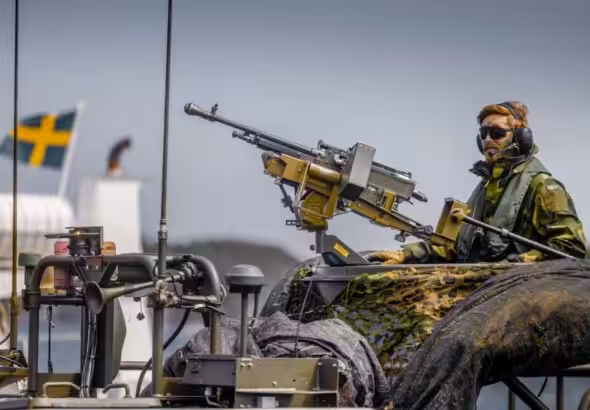 A Swedish soldier on top on an armored military vehicle in what seems to be a military drill. Photo: Getty Images