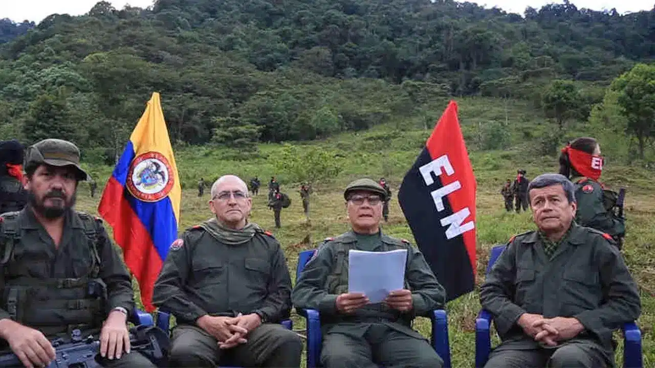 ELN commanders sat next to an ELN flag, making statements in 2018. Photo: ELN.