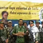 FARC dissident group Segunda Marquetalia commander Iván Márquez (center, in olive uniform), with legendary FARC guerrilla leader Jesús Santrich (wearing a kuffiyeh) to his left, from a video published in August 2019. Photo: YouTube.
