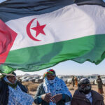 Sahrawi women raise the flag of the Sahrawi Arab Democratic Republic. File photo.