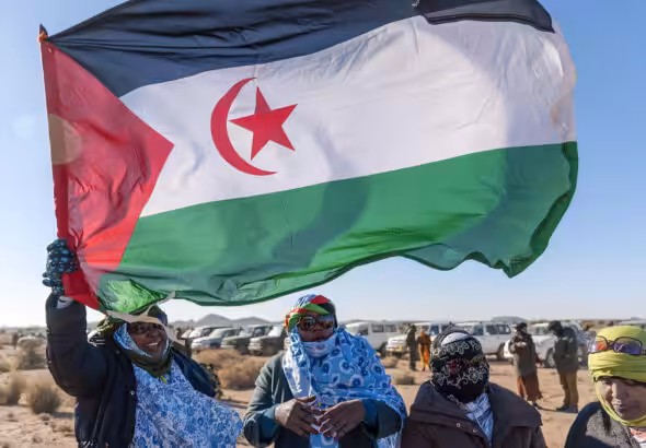 Sahrawi women raise the flag of the Sahrawi Arab Democratic Republic. File photo.