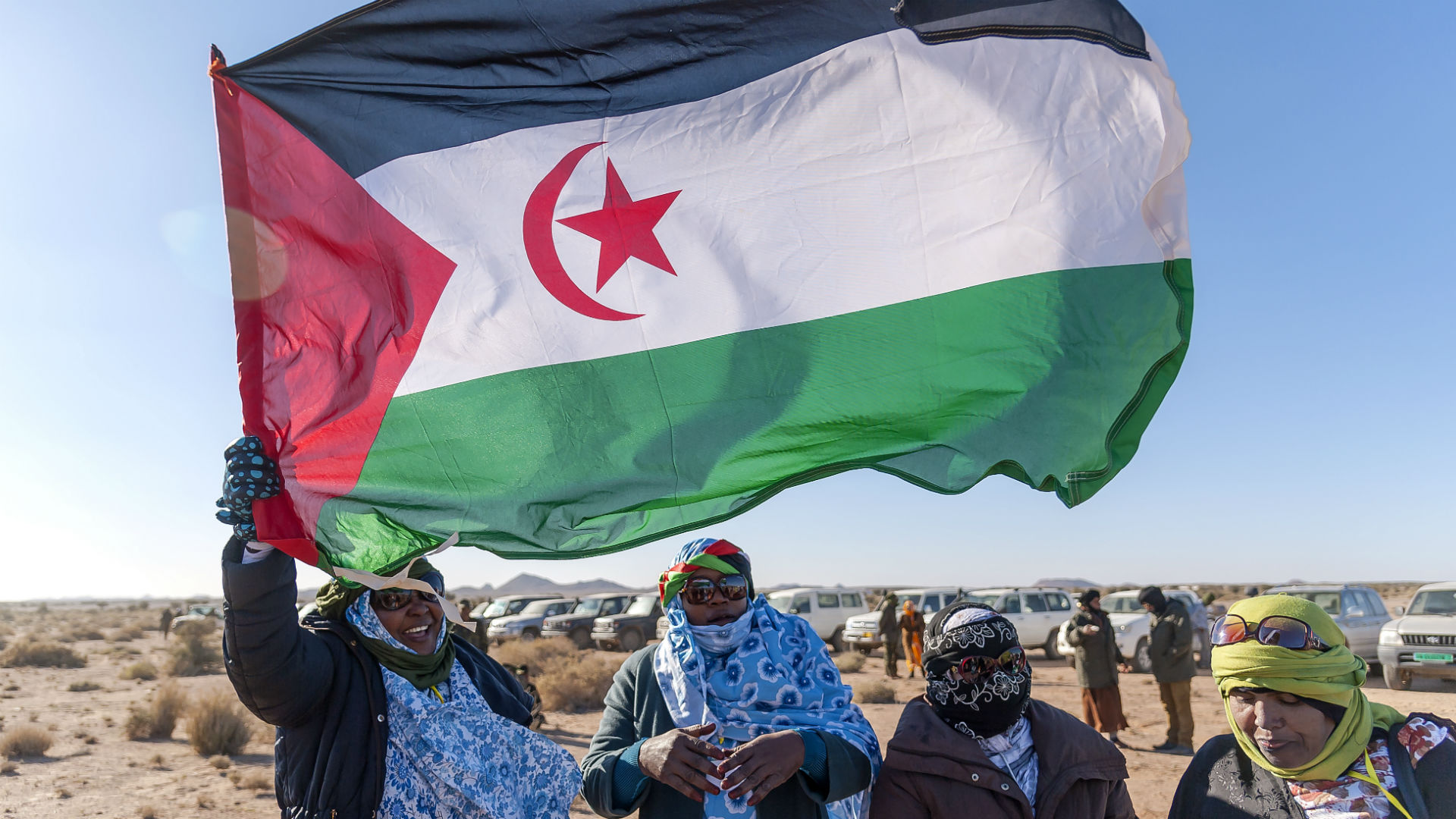 Sahrawi women raise the flag of the Sahrawi Arab Democratic Republic. File photo.